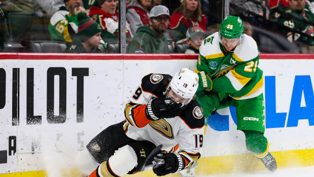 Anaheim Ducks right wing Troy Terry (19) reacts after taking Minnesota Wild defenseman Jonas Brodin's (25) stick to the face during the second period at Xcel Energy Center in St. Paul, Minn., on Jan. 27, 2024. Brodin was charged with a high sticking penalty.